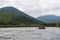 Tourists raft along the mountain river