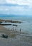 Tourists relax on the beach at the beautiful, traditional, Welsh seaside resort of Criccieth.