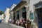 Tourists relax at the historic Asticon bar in Potamos, Greece