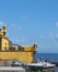 tourists relax by the sea outside the yellow fort in funchal madeira in bright sunshine