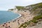 Tourists relaxing on beach at Durdle door