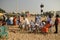 Tourists and religious people relaxing on the sea beach