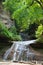 Tourists rest on the top of a waterfall