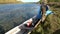 Tourists rest after trip on airboat on banks of Lena River.