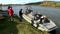 Tourists rest after trip on airboat on banks of Lena River.