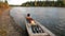 Tourists rest after trip on airboat on banks of Lena River.