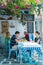 Tourists at restaurant on the beach near the four famous windmill