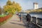 Tourists ride bicycles along the autumn embankment