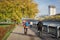 Tourists ride bicycles along the autumn embankment