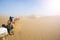 Tourists ride Camel over Sunshine Summer Desert