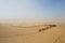 Tourists ride Camel over Sunshine Summer Desert