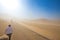 Tourists ride Camel over Sunshine Summer Desert