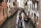 Tourists ride gondolas tour on canals