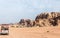 Tourists ride on a tender through the vast expanse of the red desert of Wadi Rum near Amman in Jordan