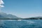 Tourists ride on white. sports boat in the sea against the backdrop of mountains in Montenegro. The concept of rich life