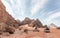 Tourists ride on white Toyota tender through vast expanse of the red desert of the Wadi Rum near Amman in Jordan