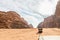 Tourists ride on white Toyota tender through vast expanse of red desert of Wadi Rum near Amman in Jordan