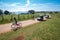 Tourists riding bicycles and driving electric golf carts in the safari park on Veliki Brijun island