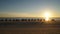 Tourists riding Camels on Cable Beach during sunset in the city of Broome, Western Australia.