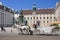 Tourists riding horse-drawn carriage. Hofburg.Vienna, Austria