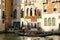 Tourists riding a traditional gondola on on the Grand Canal in Venice