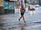 Tourists run under summer storm shower blurred motion effect