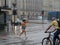 Tourists run under summer storm shower blurred motion effect