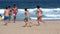 Tourists running on a beach