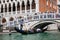 Tourists sailing in a gondola on the Grand Canal in Venice in front of the Doge Palace