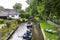 Tourists sailing on rented boats on the canal between houses in the famous village of Giethoorn. The village is called the Venice