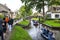 Tourists sailing on rented boats on the canal between houses in the famous village of Giethoorn. The village is called the Venice