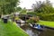 Tourists sailing on rented boats on the canal between houses in the famous village of Giethoorn. The village is called the Venice