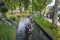 Tourists sailing on rented boats on the canal between houses in the famous village of Giethoorn. The village is called the Venice