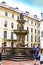 Tourists at the second courtyard of Prague Castle Prazsky hrad with Kohl Fountain