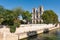 Tourists in the Seine banks with Notre-Dame cathedral in the ba