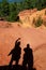 Tourists shadows waving to Le Sentier des Ocres in Roussillon in