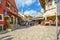 Tourists shop for gifts and souvenirs as diners enjoy a sidewalk cafe on the cobblestone streets of medieval Old Town Mostar, Bosn