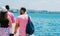 Tourists sightseeing a city while walking on a boardwalk on a sunny summer day