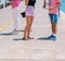 Tourists sightseeing a city while walking on a boardwalk on a sunny summer day