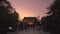 Tourists sightseeing golden Ueno Toshogu shrine lightened by lanterns at twilight.