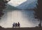 Tourists sit on a bench on the shore of the Alpine lake