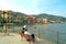 Tourists sitting on a bench on the pier