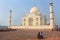 Tourists sitting on a bench at Taj Mahal complex, Agra, Uttar Pr