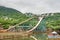 Tourists sitting on boat doing extreme sport water slide with splash on the track in park of Overseas Chinese Town East OCT East