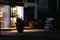 Tourists sitting on steps of shop at night in the small quaint town of  CaetÃª-AÃ§u, Chapada Diamantina, Brazil