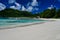 Tourists spending time on the beach - Baie Lazare beach, Mahe Island, Seychelles.