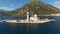 Tourists stand in front of the entrance to the Church of Our Lady of the Rocks. Perast, Montenegro