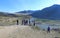 Tourists stand on the high Bank of the Katun river in the Altai Mountains in Russia