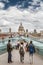 Tourists stand on the Millennium Bridge looking at St Pauls