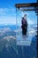 Tourists stand in the `Step into the Void` glass box on the Aiguille Du Midi